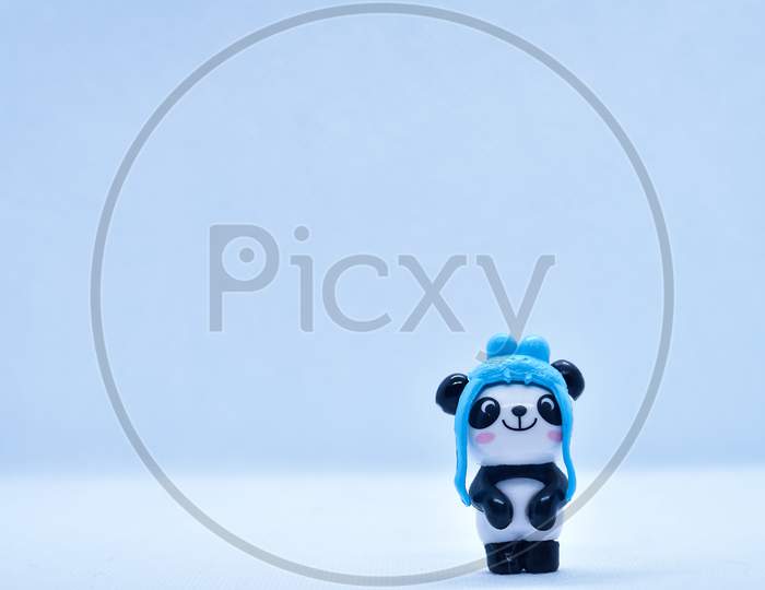 Little Panda Porcelain Figurine Isolated On Black Background