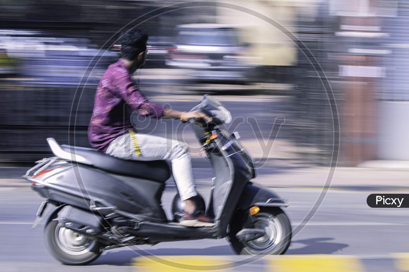 Scooter Rider in Motion Blur Photograph