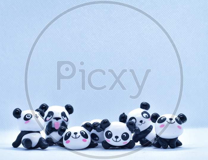 Little Panda Porcelain Figurines Isolated On Black Background