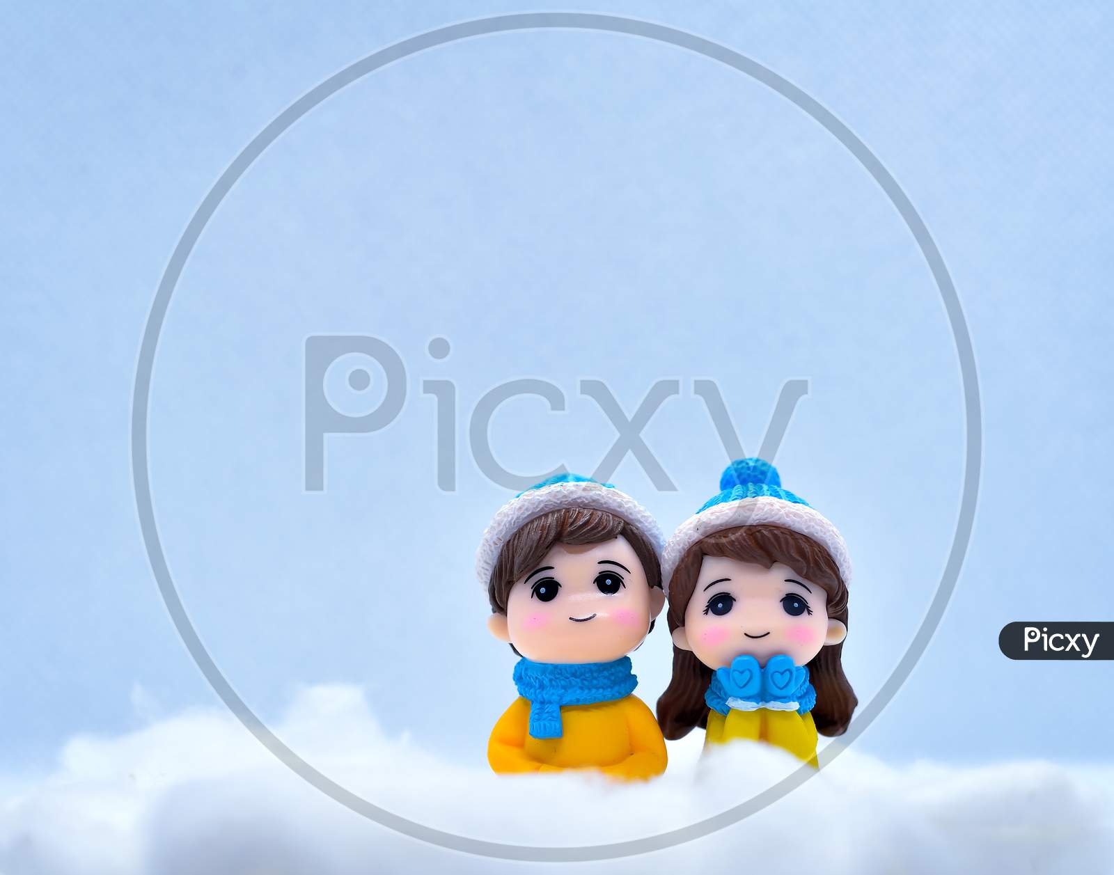 Tourism And Travel Concept: Miniature People In Winter Snow Along With Little Snowman