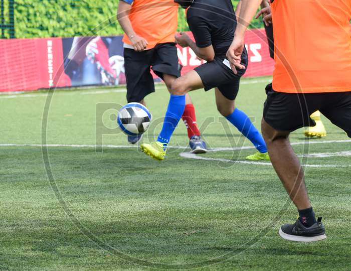 New Delhi, India - January 26 2020: Footballers Of Local Football Team During Game In Regional Derby Championship On A Bad Football Pitch. Hot Moment Of Football Match On Grass Green Field Of The Stadium
