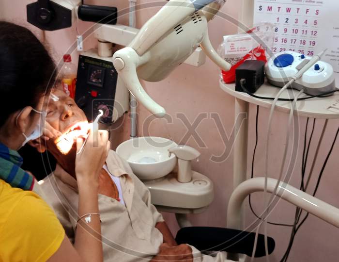 Indian Dental Specialist Doctor Working At Clinic.