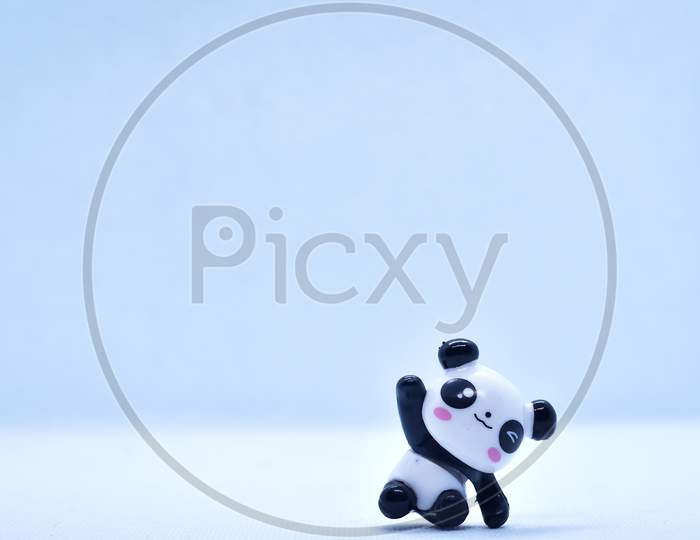 Little Panda Porcelain Figurine Isolated On Black Background