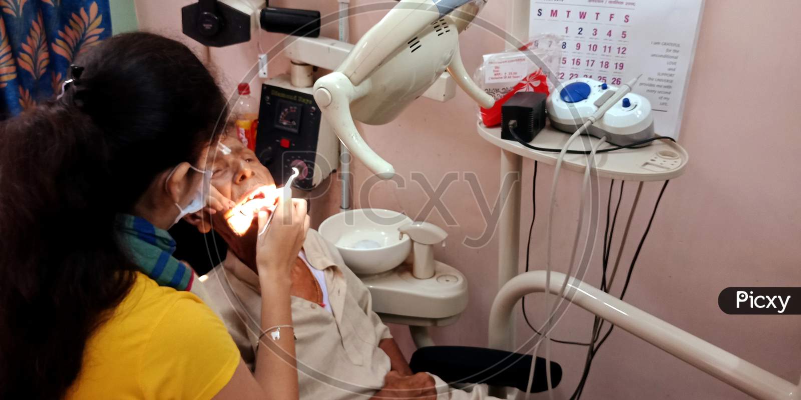 Indian Dental Specialist Doctor Working At Clinic.