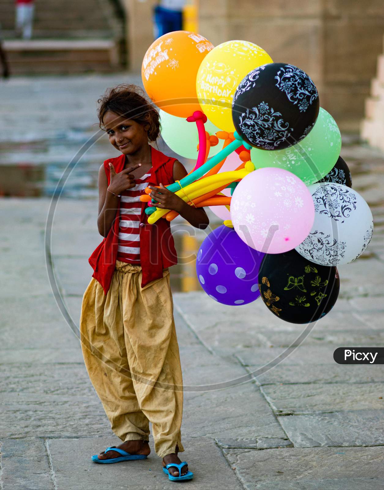 A little girl selling balloon on Varanasi ghats
