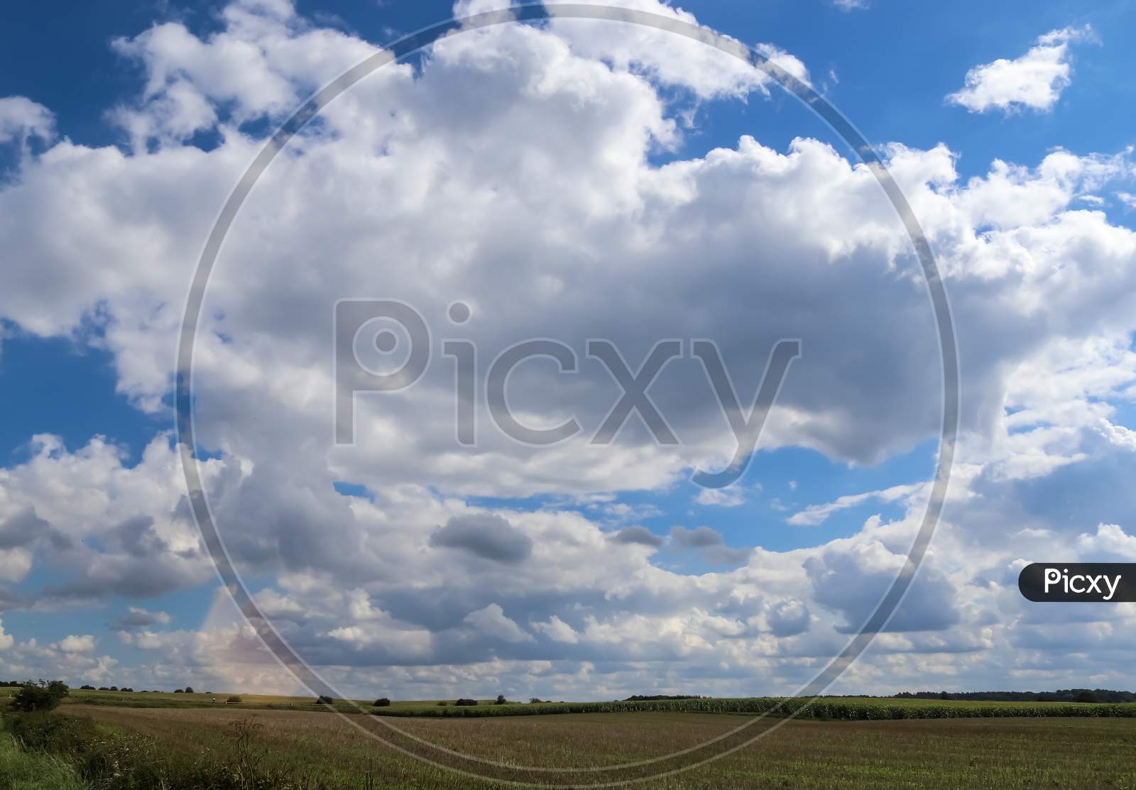 Beautiful Clouds In A Blue Sky In A Northern European Agriclutural Landscape