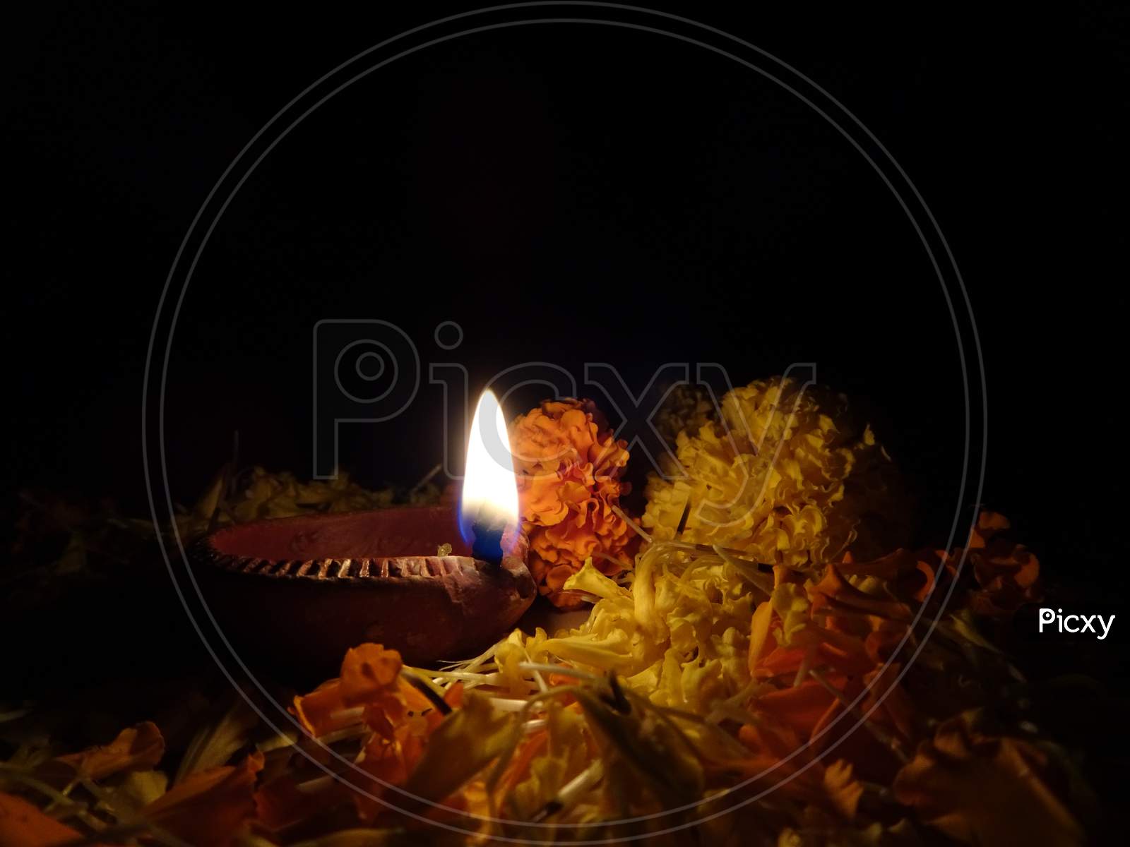 Celebrating diwali with rangoli, flowers and diya