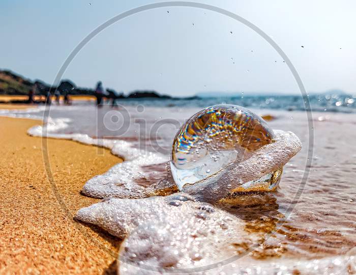 Lensball at the beach with waves