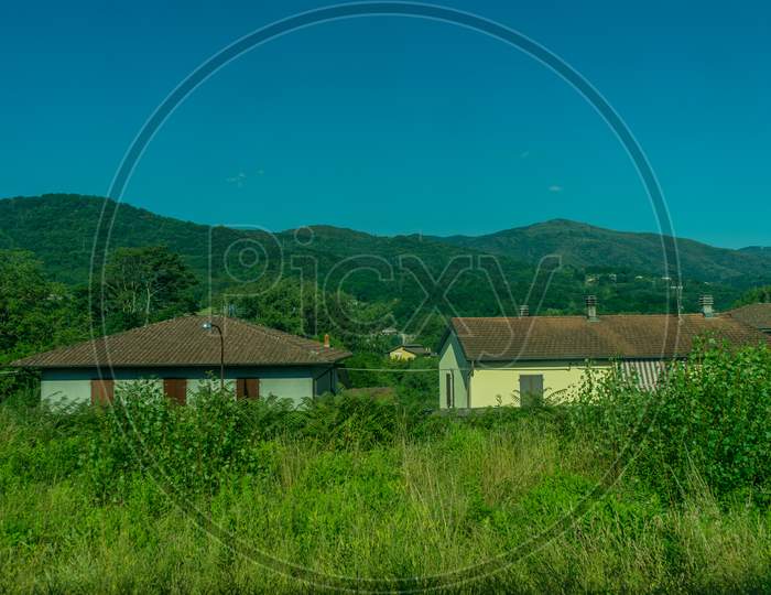 Italy,La Spezia To Kasltelruth Train, A House With A Grass Field