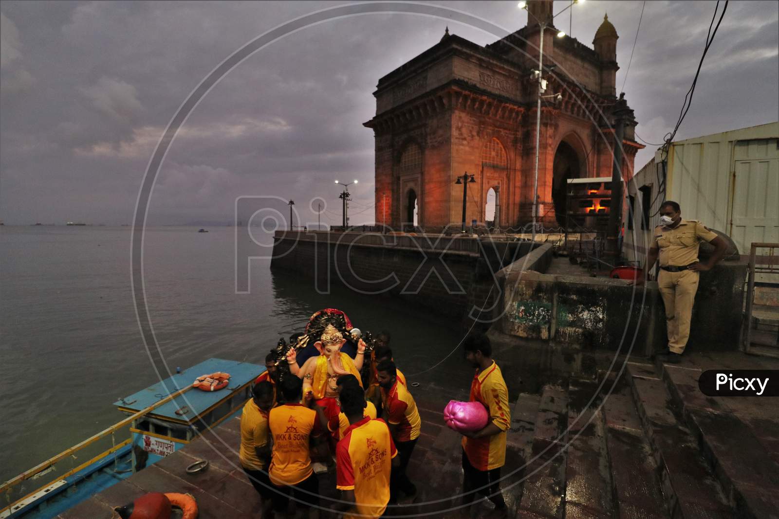 Volunteers carry an idol of Hindu God Ganesha, to immerse in the Arabian Sea, marking the end of the 10-day long Ganesh Chaturthi festival at the Gateway of India, in Mumbai, India on September 1, 2020