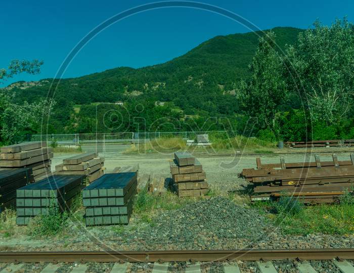 Italy,La Spezia To Kasltelruth Train, A Wooden Bench Sitting In The Grass
