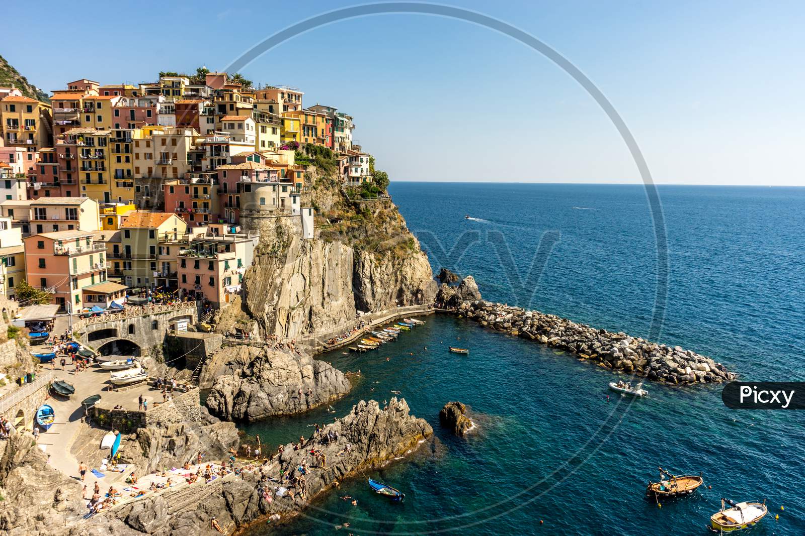 Italy, Cinque Terre, Manarola, Manarola, Panoramic View Of Sea And Buildings Against Clear Blue Sky
