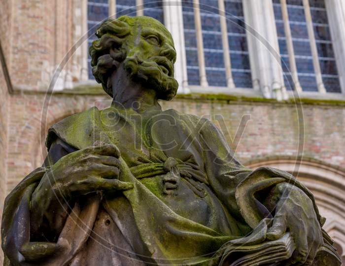 Bruges, Belgium - 17 February 2018: Statue In Front Of Church Of Our Lady In Bruges, Belgium