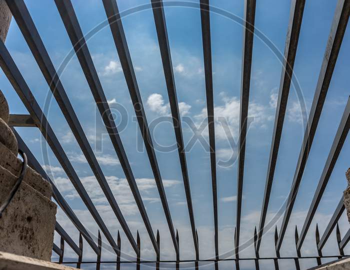 Blue Sky In Rome Viewed Through A Ceiling Fence