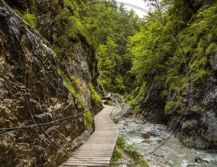 Hiking through the so called Grießbachklamm, a little creek leading through a gorge canyon at a cloudy day in summer.