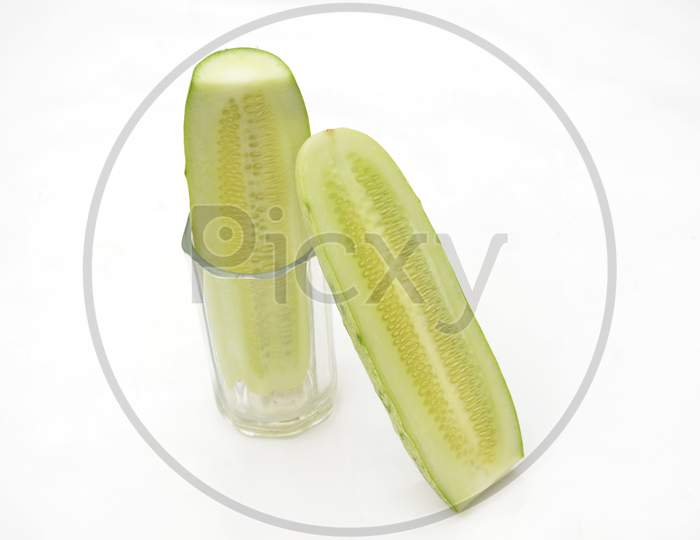 Sliced Cucumber In The Glass With Cucumber Isolated On White Background.