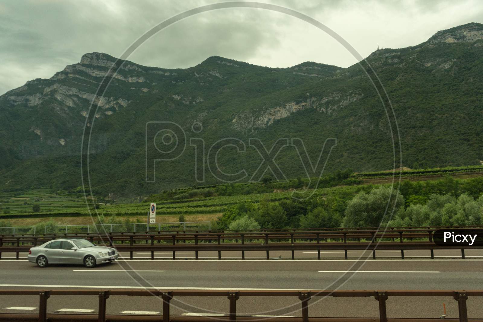 Italy - 28 June 2018: The Road Highway In The Italian Outskirts With A Mercedes Car