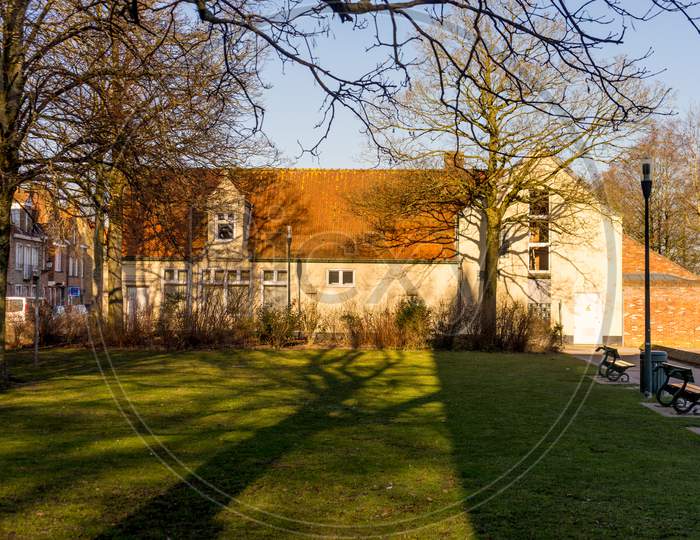 Bruges, Belgium - 17 February 2018:Grass Lawn In Front Of A Cozy Cottage