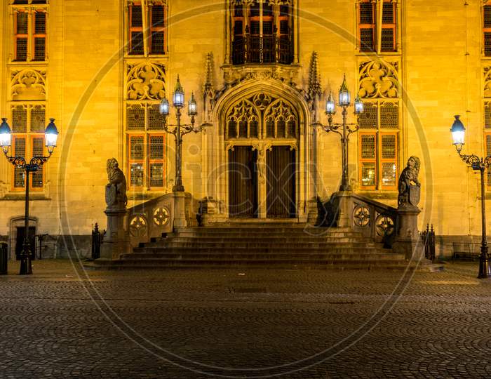 Belgium, Bruges, A Person Standing In Front Of A Building