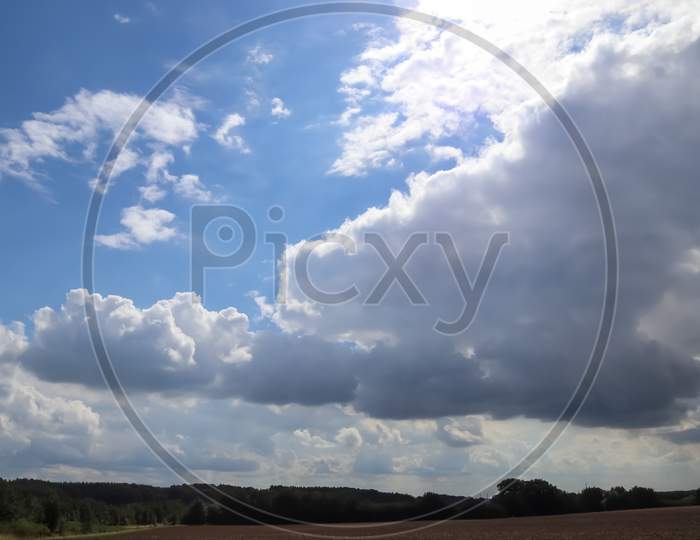 Beautiful Clouds In A Blue Sky In A Northern European Agriclutural Landscape