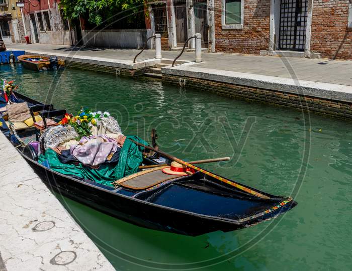 Gondola Boat On The Canals Of Venice, Italy