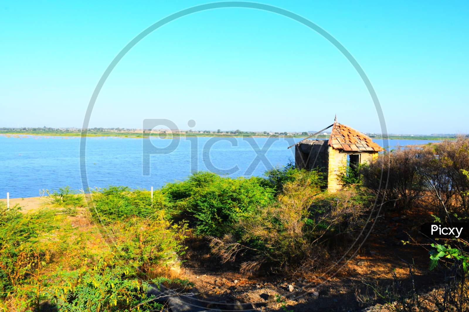 Hut on banks of the river of India, old hut, Little old house on banks of the river at sunset in silence