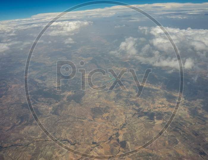 The Land On Earth Viewed From Aeroplane In Sky With Clouds, Spain