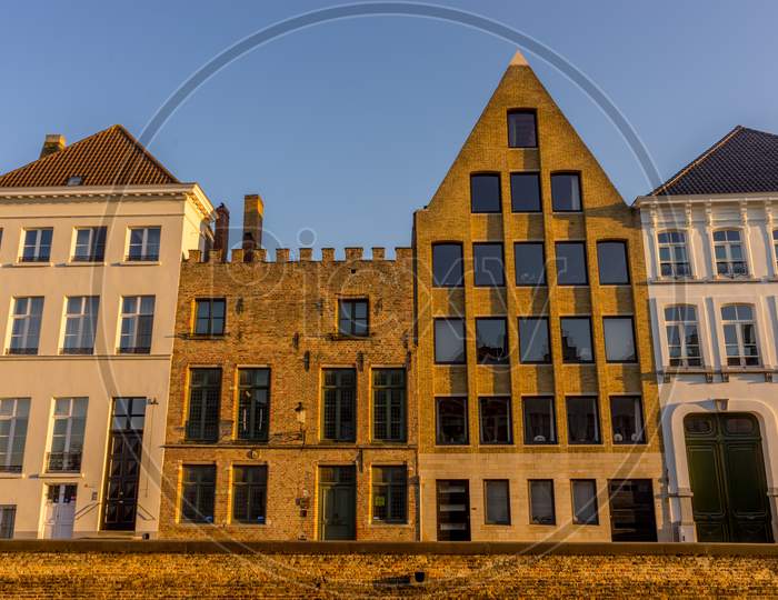Belgium, Bruges, A Large Brick Building With Many Windows