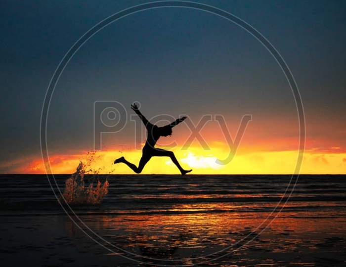 Evening photography of sunset time and jumping man