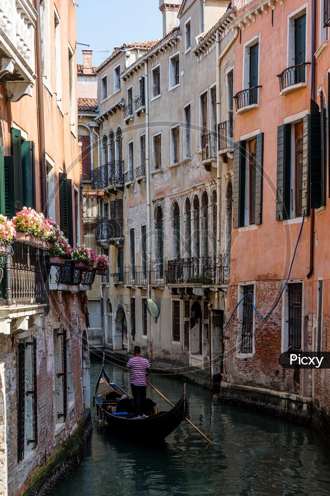 Italy, Venice, Gondolier Navigating A Gondola Near San Moise On A Canal