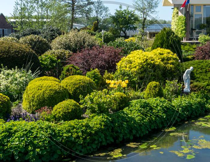 Lisse, Netherlands - 5 May 2018: A Dutch Villa Along A Pond