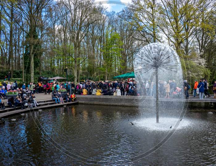 Keukenhoff, Netherlands - April 17 : The Keukenhoff Tulip Gardens On April 17, 2016. Tourists Gather Near The Water Fountain