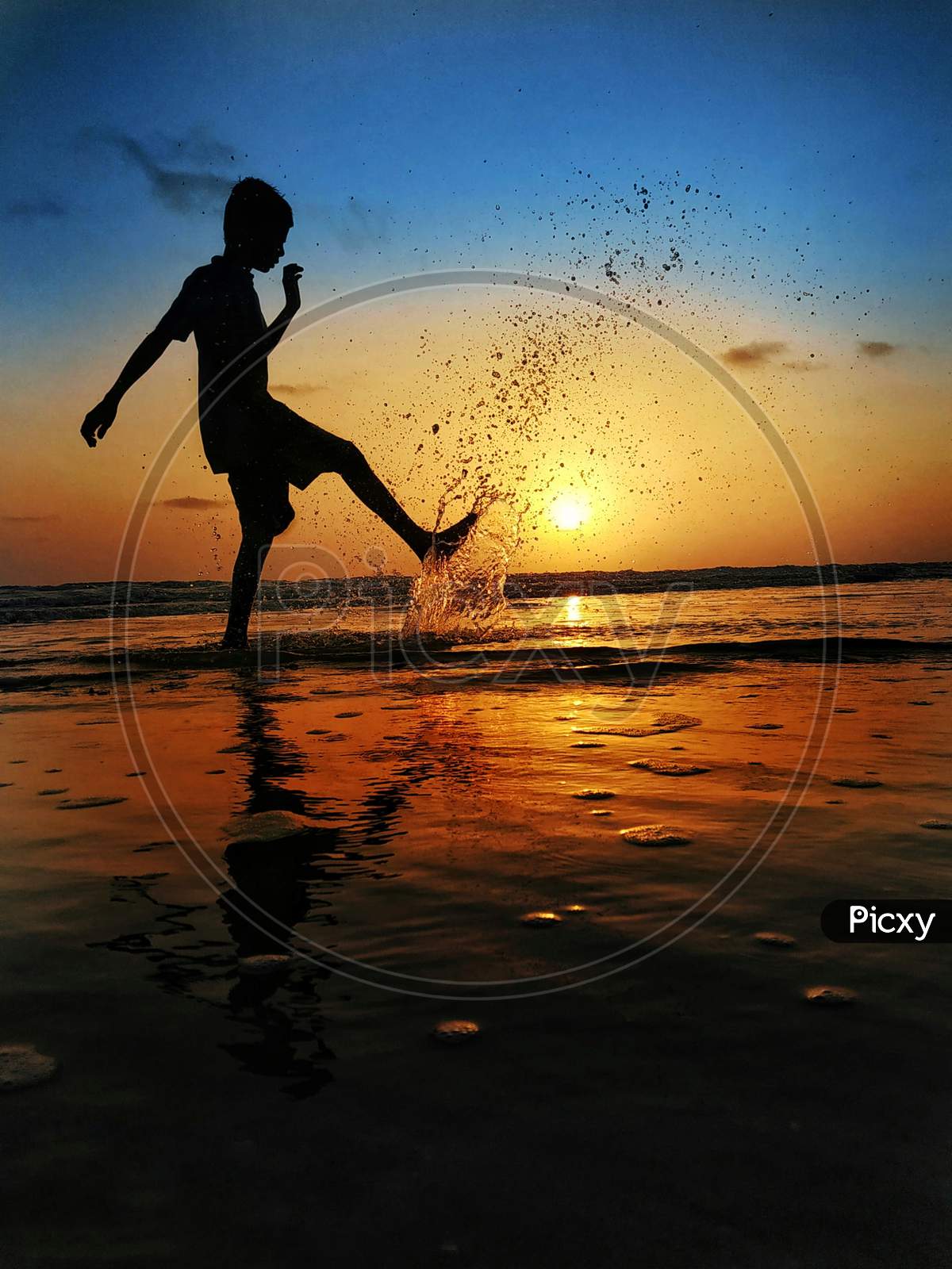 boy play evening time in sea