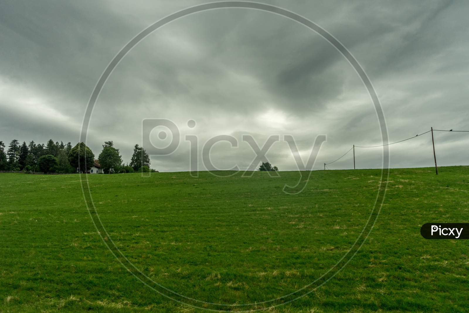 Italy,La Spezia To Kasltelruth Train, A Large Green Field With Clouds In The Sky