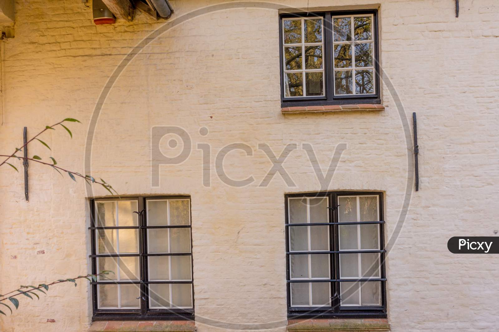 Belgium, Bruges, A Glass Window Against White Wall