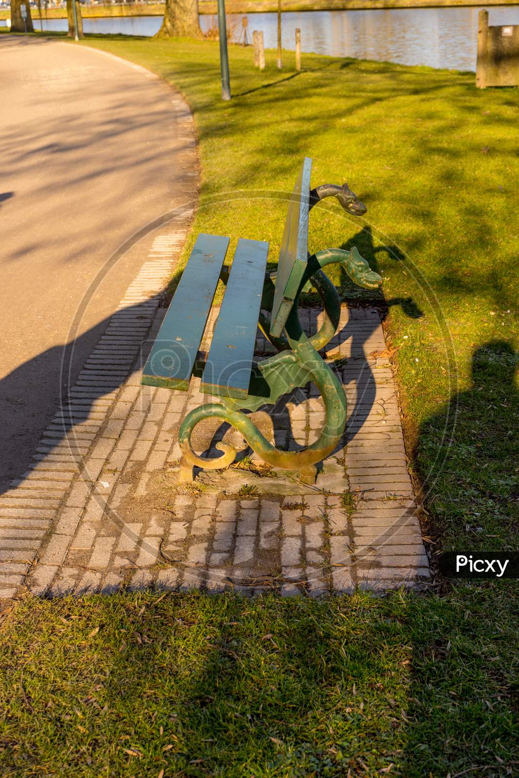 Belgium, Bruges, A Bench That Is Sitting In The Grass