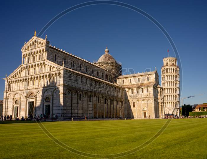 Pisa, Italy - 25 June 2018: The Leaning Tower Of Pisa At Piazza Del Miracoli Duomo Square,Camposanto Cemetery In Tuscany, Italy