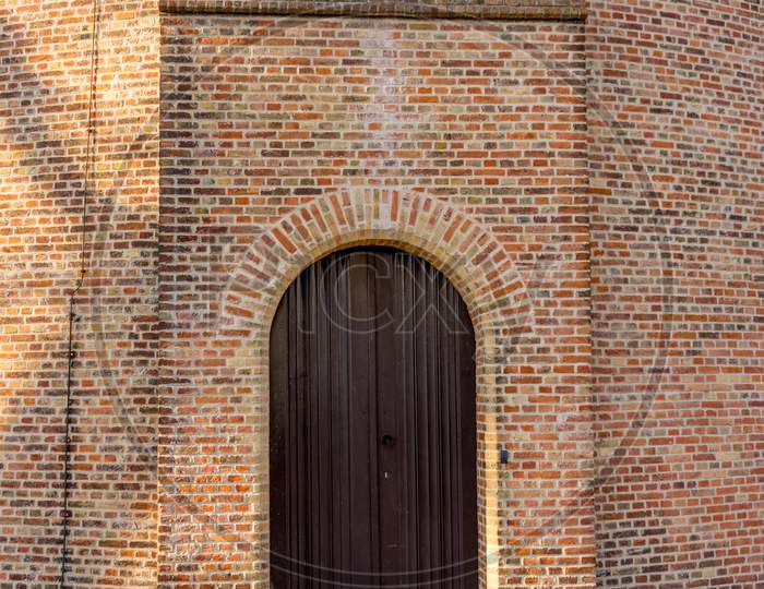 Belgium, Bruges, Entrance Under Arch Of An Old Brick Building