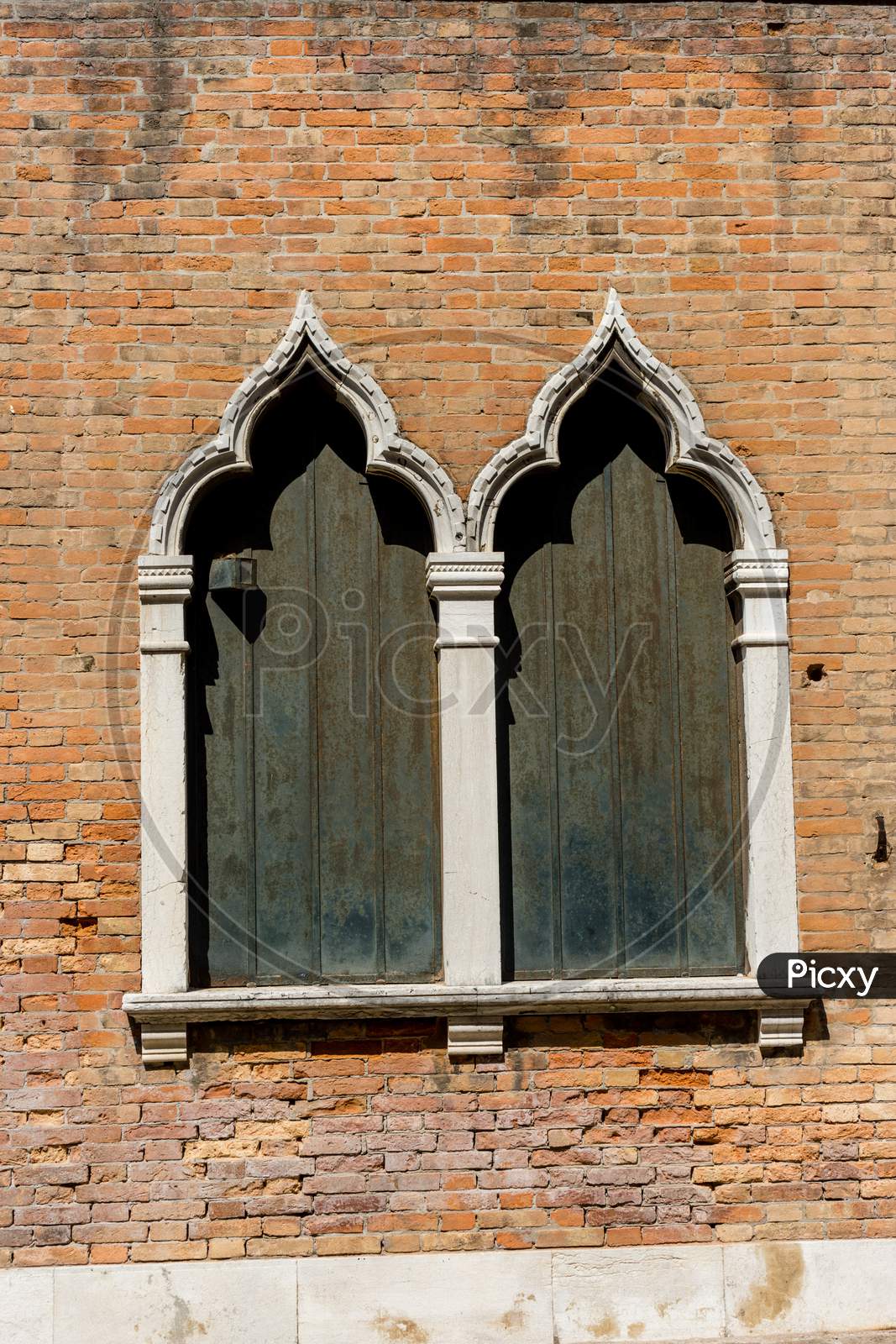 Italy, Venice, A Large Brick Building With Many Windows