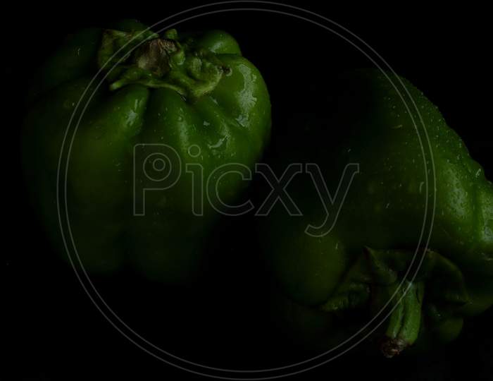 Green bell pepper on black backgound