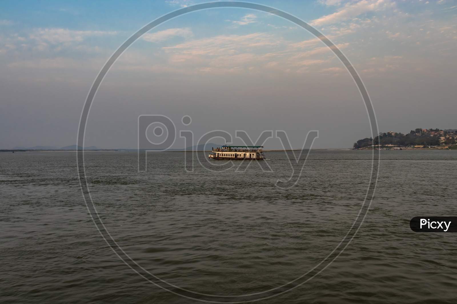 Ship Heading Towards River Island At Dusk