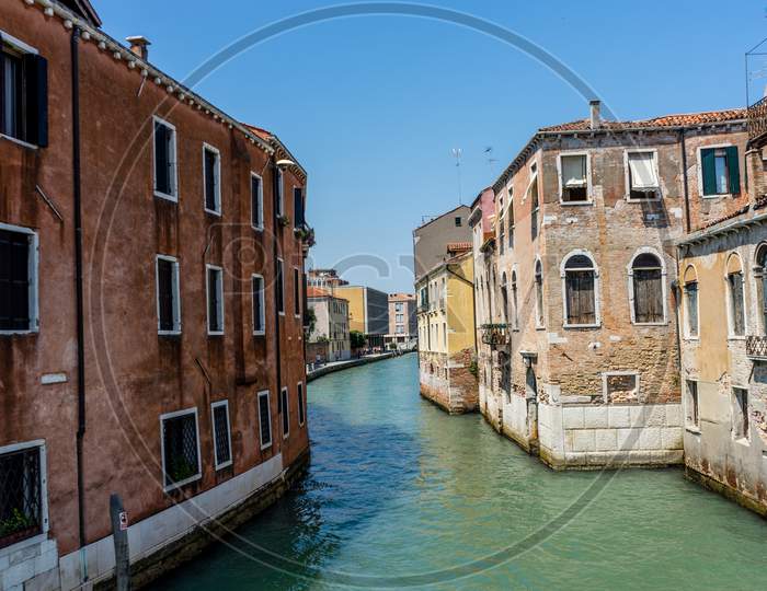 Italy, Venice, Hotel Pantalon, Canal Amidst Buildings Against Clear Sky