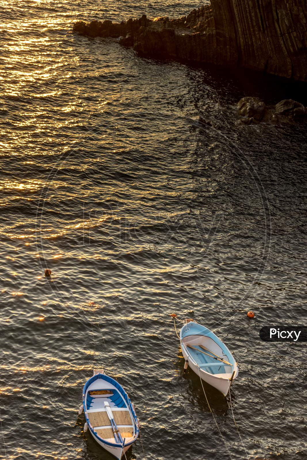 Boats On The Ocean During Sunset, Italian Riviera Of Riomaggiore, Cinque Terre, Italy