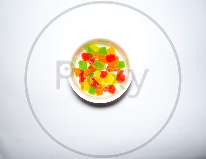 cute little candy in a white bowl with white background