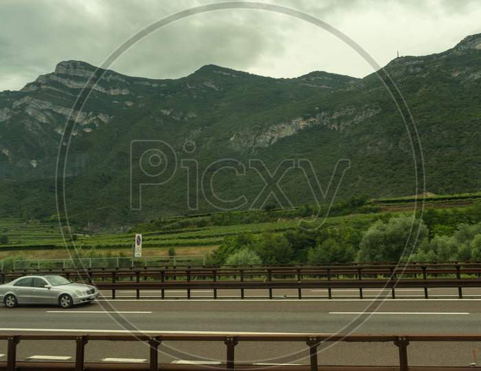 Italy - 28 June 2018: The Road Highway In The Italian Outskirts With A Mercedes Car