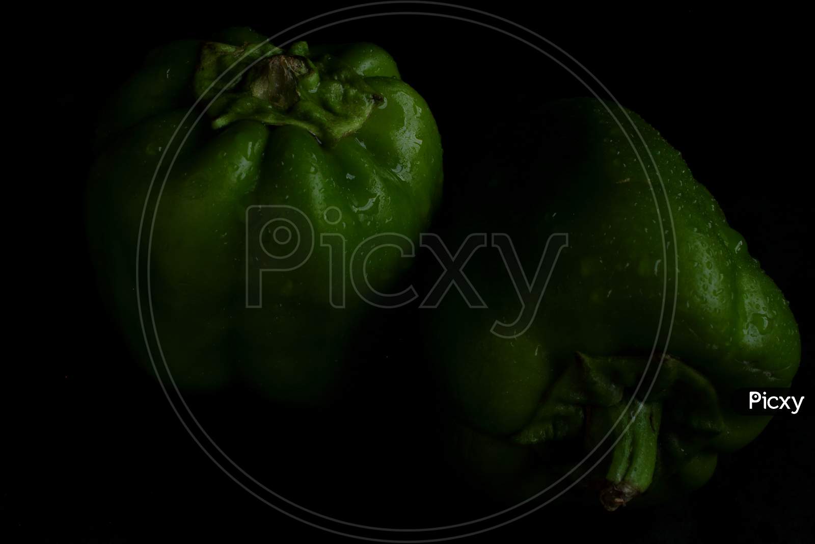 Green bell pepper on black backgound