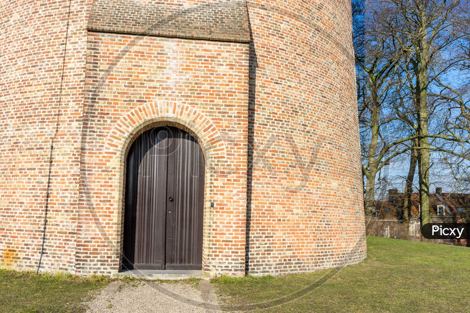 Belgium, Bruges, Wooden Door Against Red Brick Building