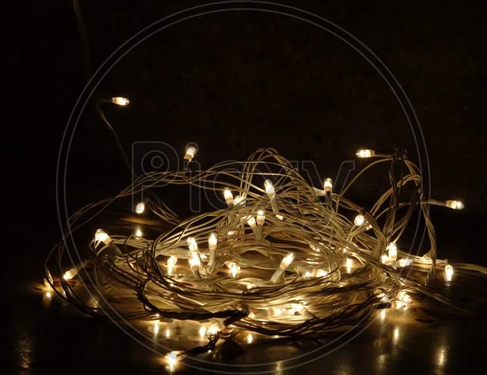 Beautiful sparkling yellow white tiny lights in night with dark background