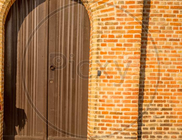 Belgium, Bruges, A Wooden Door In Front Of A Brick Building