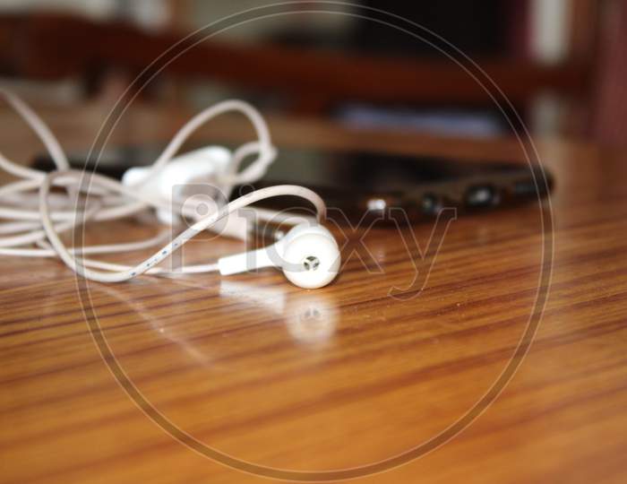Earphone and phone on table